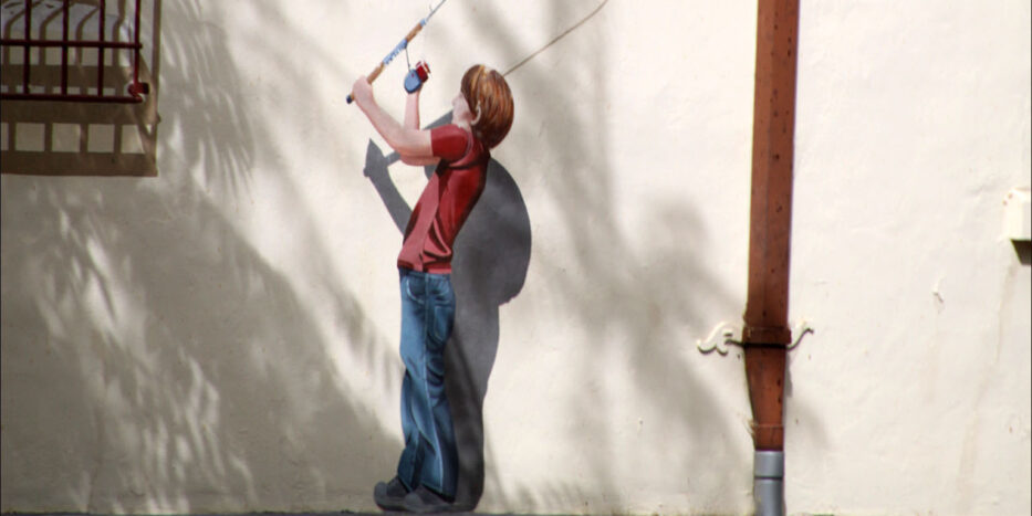 A boy with a fishing rod mural